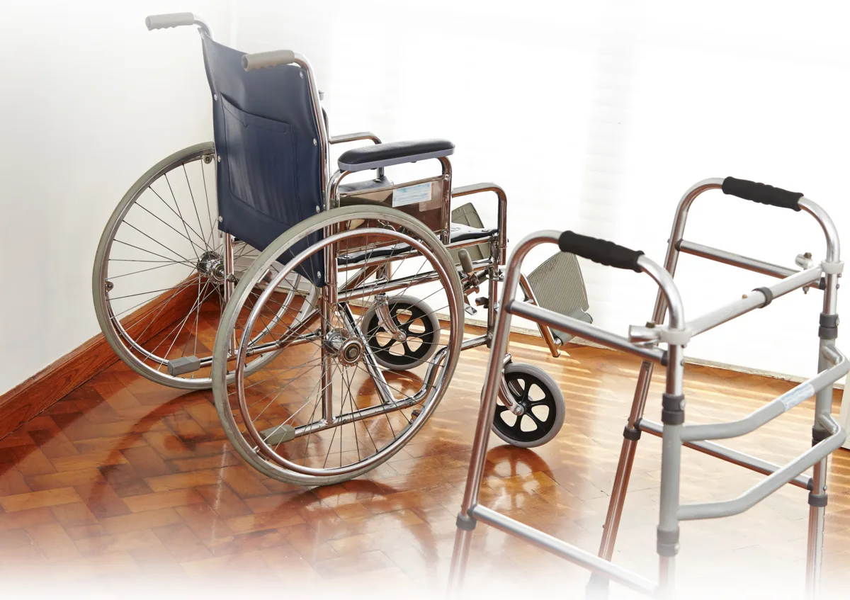Empty wheelchair and wallker in nursing home as symbol for death